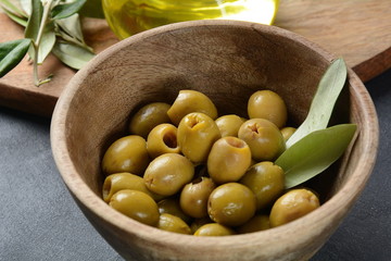 Extra virgin Olive oil , olive branch and olives on a dark background