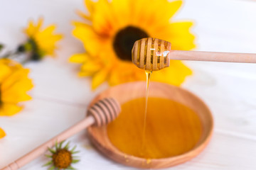 Natural honey with herbs on white wooden background. Organic food, healthy food, sugar dessert