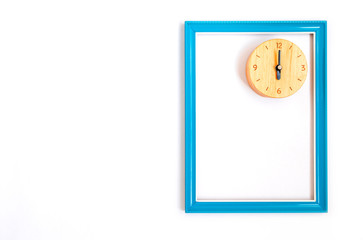 Top view and copy space of blue picture frame made wooden with clock inside. Placed on white background.