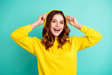 Photo of cheerful cute nice charming pretty sweet putting her hood on smiling toothily beaming...