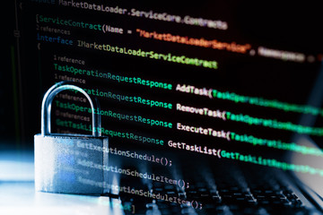 Padlock on laptop with a programming language. Internet data privacy information security concept....