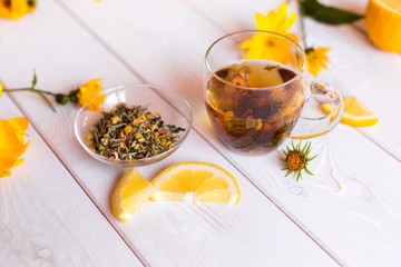 Herbal natural hot tea with different herbs,lemon and honey. Vitamins, healthy lifestyle concept