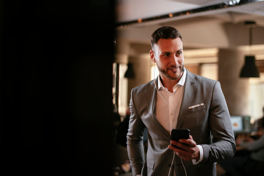 Businessman In Grey Suit With Headphones