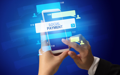 Female hand typing on smartphone with SOCIAL PAYMENT inscription, social networking concept