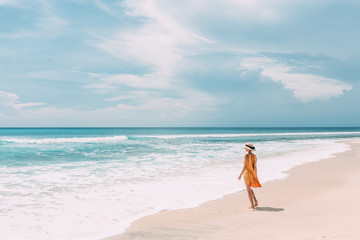 Woman walking in blue lagoon with paradise view