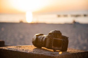 professional dslr camera on the sand on the beach. Dust proof