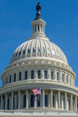 Fototapeta na wymiar U.S. Capitol dome with U.S. and POW/MIA flags