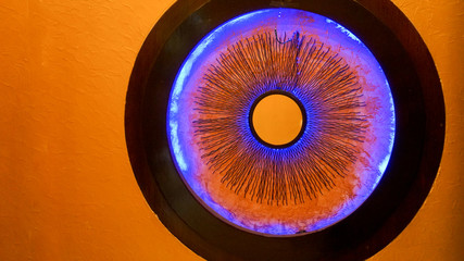 Round mirror looking like human eye’s iris. Black magic concept.