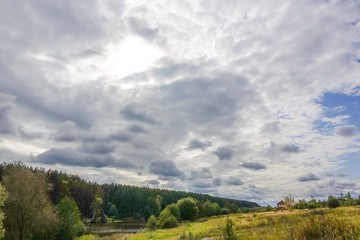 The sky covered by clouds over the forest. Russia. Autumn