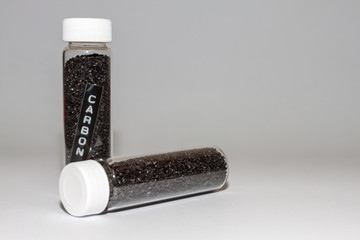 activated carbon or granular in clear bottle is used in air purification, decaffeinate, gold purification, metal extraction, water purification, medicine, sewage treatment, air filters in gas masks