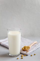 Soy milk in a glass glass. Vegetarian food. Organic products, healthy food concept. Vertical orientation, side view, copy space.