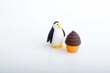 Penguin and ice cream rubber toys, cute animal shaped rubber doll isolated in white background.