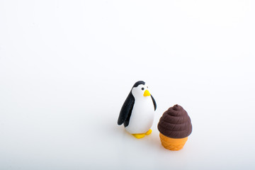 Penguin and ice cream rubber toys, cute animal shaped rubber doll isolated in white background.