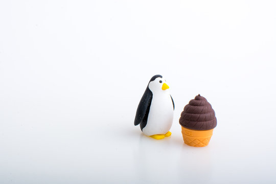 Penguin and ice cream rubber toys, cute animal shaped rubber doll isolated in white background.