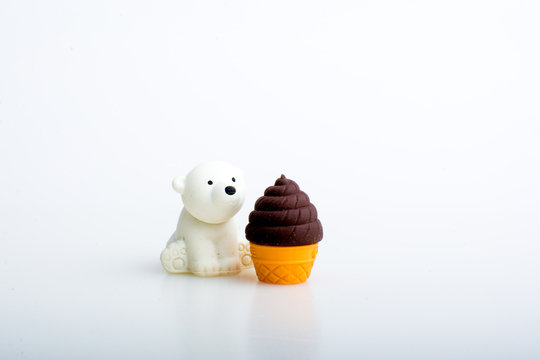 Polar bear with ice cream rubber toys, cute animal shaped rubber doll isolated in white background.
