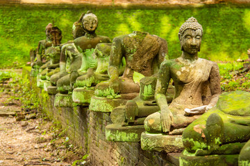 The old Buddha statue and moss at Tunnel Temple (Wat U-mong), Chiang Mai Province, Asia Northern Thailand