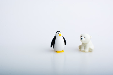 Penguin and polar bear rubber toys, cute animal shaped rubber doll isolated in white background. 