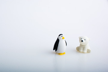 Penguin and polar bear rubber toys, cute animal shaped rubber doll isolated in white background. 