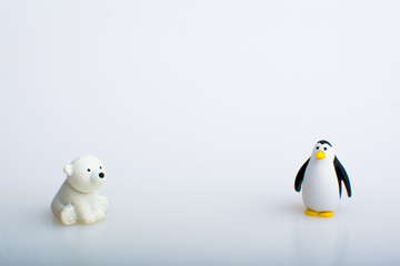Penguin and polar bear rubber toys, cute animal shaped rubber doll isolated in white background. 