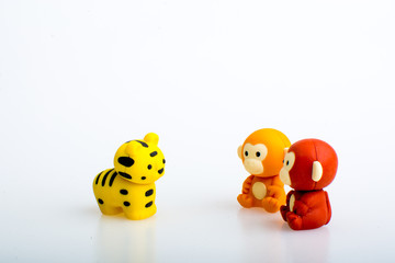 Two monkey and a tiger rubber toys, cute animal shaped rubber doll isolated in white background. 