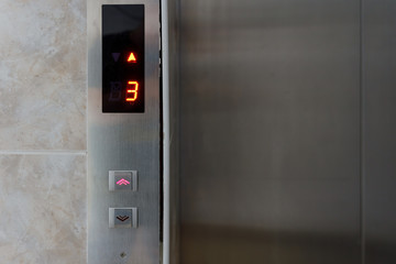 Metallic elevator panel with button and led display.  Interior and closeup of metal buttons in elevator © Илья Подопригоров