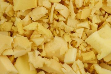 yellow polyurethane foam rubber pieces background texture. stuffing for pillows and furniture
