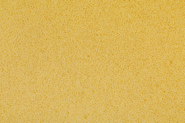 yellow polyurethane foam rubber pieces background texture. stuffing for pillows and furniture - obrazy, fototapety, plakaty