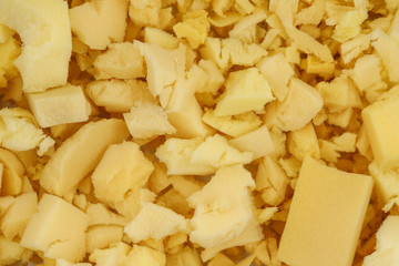 yellow polyurethane foam rubber pieces background texture. stuffing for pillows and furniture