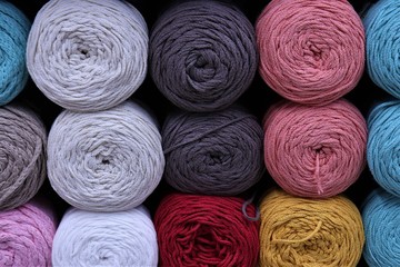 multi-colored balls of yarn: blue, white, gray, pink, dark brown