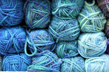 multi-colored balls of yarn: blue, green, lilac