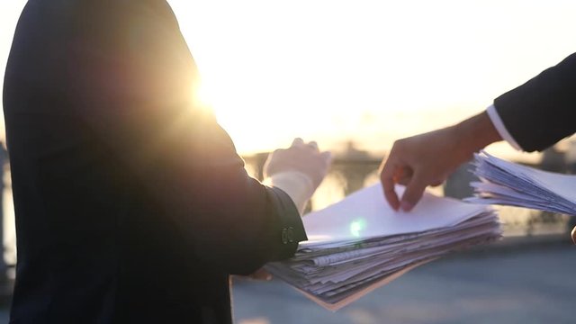 Business partners are busy with important documents, point fingers at a sheet of paper. A man in a jacket throws papers up. separated from debts. HD, 1920x1080, slow motion