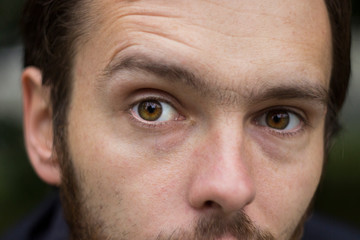 Particles on angry elder eyes with corrugated forehead