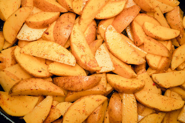 Potato slices in spices background texture