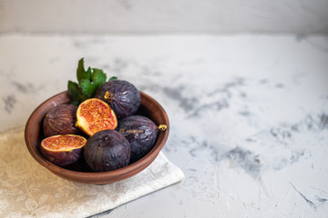 Ripe, beautiful, purple figs. Sweet and juicy. Mediterranean fruit is very healthy. On a light gray background copyspace there is an empty place. Food for vegetarians.