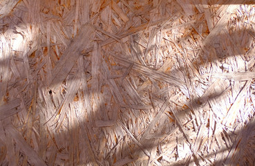 Background. Natural wooden pressed shavings. Chipboard sheet close up, the background is empty