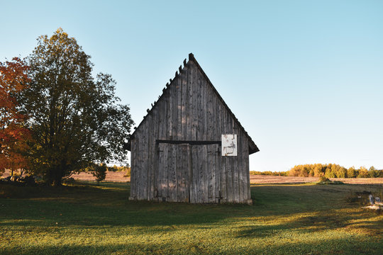 An old wooden barn on a field in autumn
