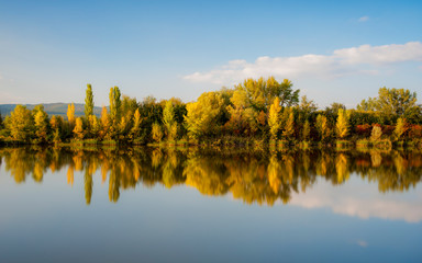 Fototapeta premium Reflection of autumn foliage in a lake