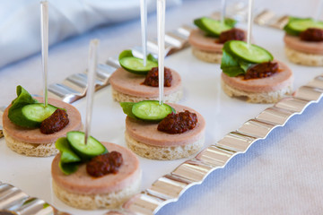 Canapes with Lettuce Sausage and Tomato. Selective focus