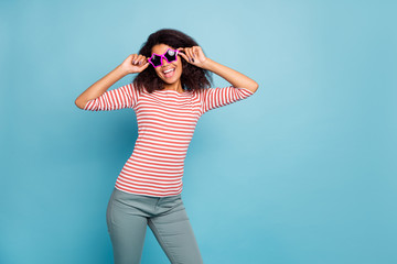 It's friday o'clock. Photo of funny dark skin lady ready start party wear star shaped sun specs casual clothes isolated pastel blue color background