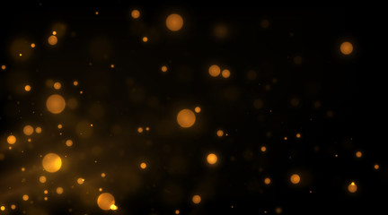 Fototapeta na wymiar Glowing golden particles on black background