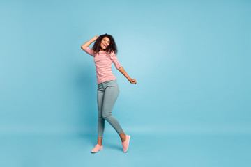 Full size photo of funny dark skin wavy lady enjoy amazing party mood funny chilling dancing wear casual clothes isolated pastel blue color background