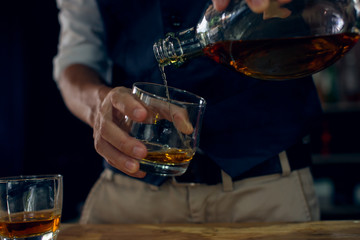 bartender pouring a drink