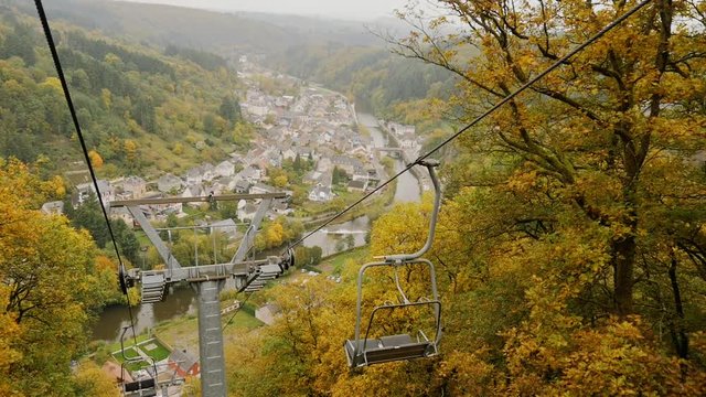 View from a cable car going up with the Vianden city in the background during a typical autumnal day in Luxembourg.