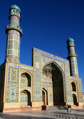 Herat in western Afghanistan. The Great Mosque of Herat (Friday Mosque or Jama Masjid). The mosque is decorated with mosaics and Quranic calligraphy. Friday Mosque with people in Herat, Afghanistan.