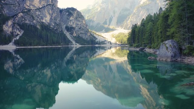 Man Alone on a Lake Aerial 4K Cinematic Shot with Mountain Lake.Italy Dolomites 4k Footage Drone Shot in UHD 4K