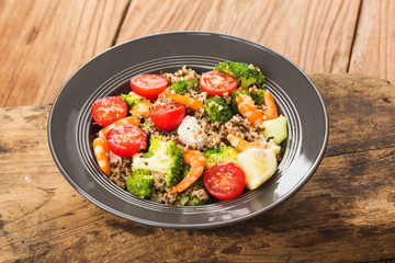 Buckwheat salad with broccoli chicken breast shrimp, Three-color quinoa salad. Superfood and healthy eating concept.