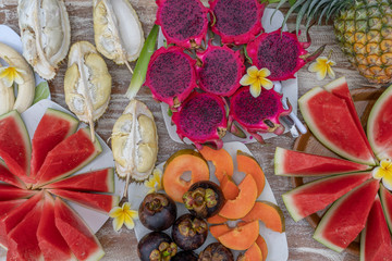 Obraz na płótnie Canvas Tropical fruits assortment, closeup, top view. Many colorful ripe fruits background. Durian, papaya, watermelon, banana, mangosteen, pineapple and pitahaya or dragon fruit in island Bali, Indonesia