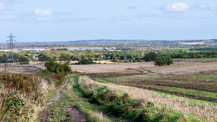 Fototapeta na wymiar Cultivated fields with the city of Sunderland way off in the background.