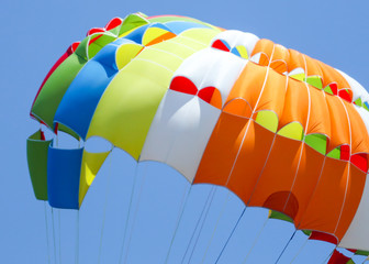 A multi-colored dome of a parachute in the sky as a background