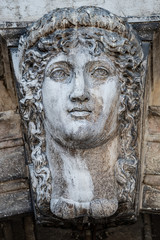 Ancient aged sculpture of beautiful Venetian Renaissance Era woman in Venice, Italy